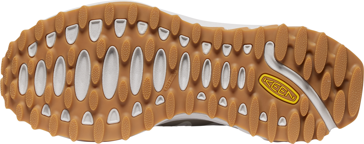 A shoe's brown sole features oval cutouts and a yellow "KEEN" logo.