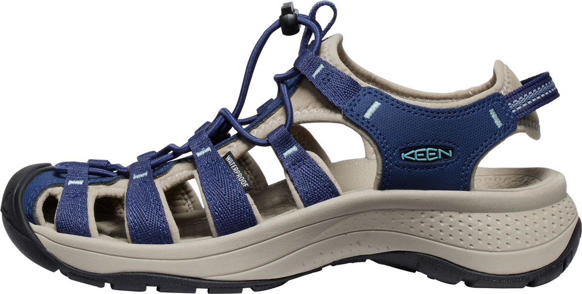 Navy and tan sandal with cord laces and toe protection.