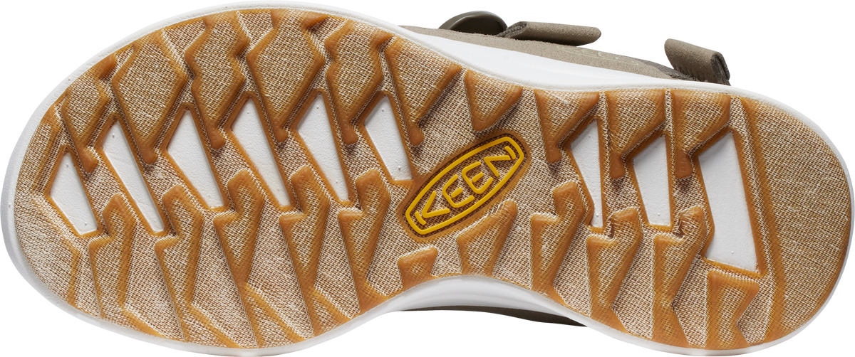 The bottom view of a shoe shows a brown tread pattern featuring diamond and rectangular shapes. In the center, a yellow logo with the text 'KEEN' is visible.