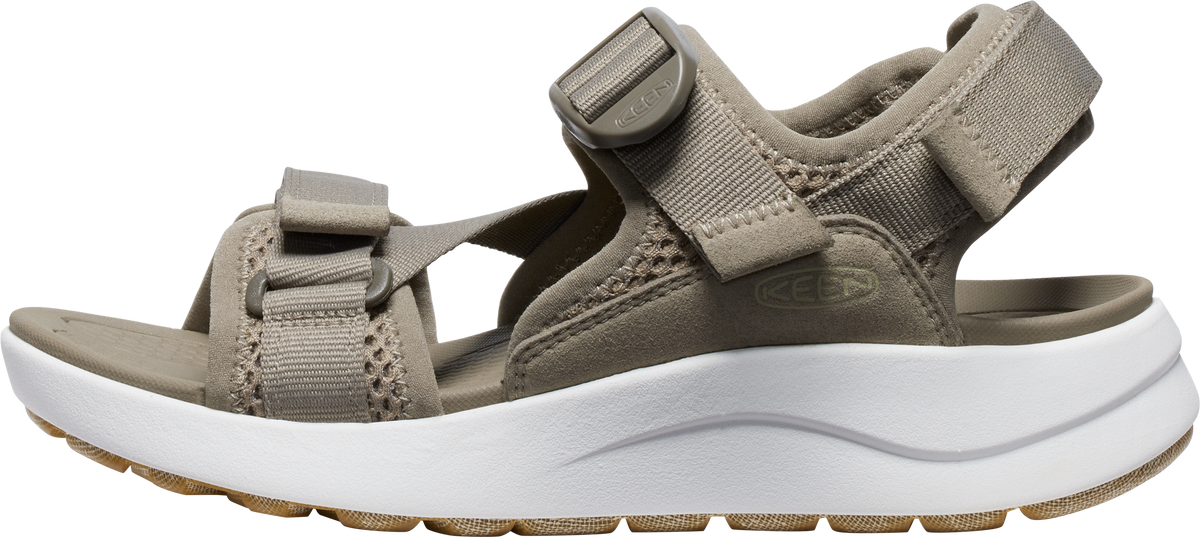 A beige sandal with white platform soles.