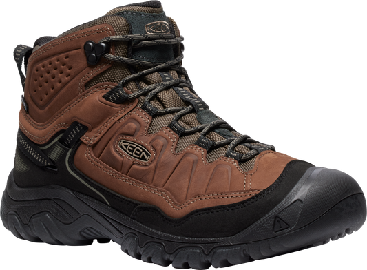 Brown and black hiking boot with laces and thick treaded sole.