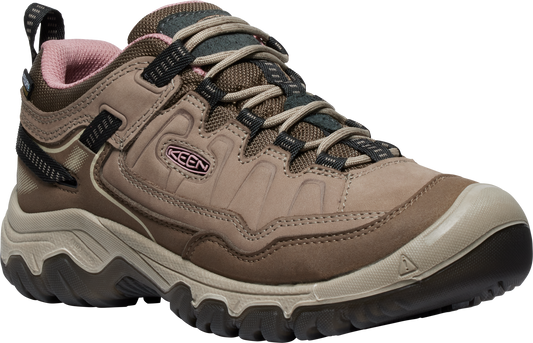 A tan colored low-rise hiking shoe with pink inner lining.