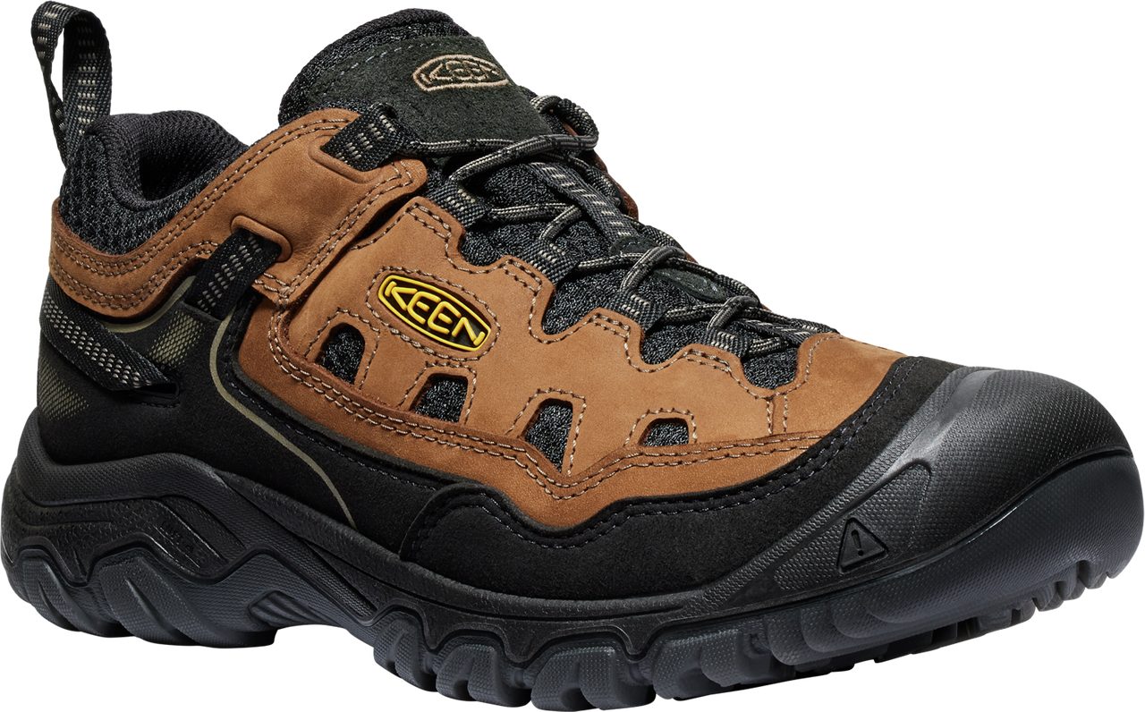 Low-cut hiking shoe with brown leather panels, black laces, black sole, and a yellow logo.