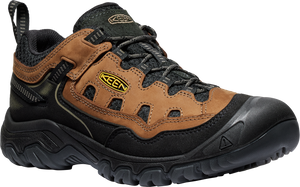 Low-cut hiking shoe with brown leather panels, black laces, black sole, and a yellow logo.