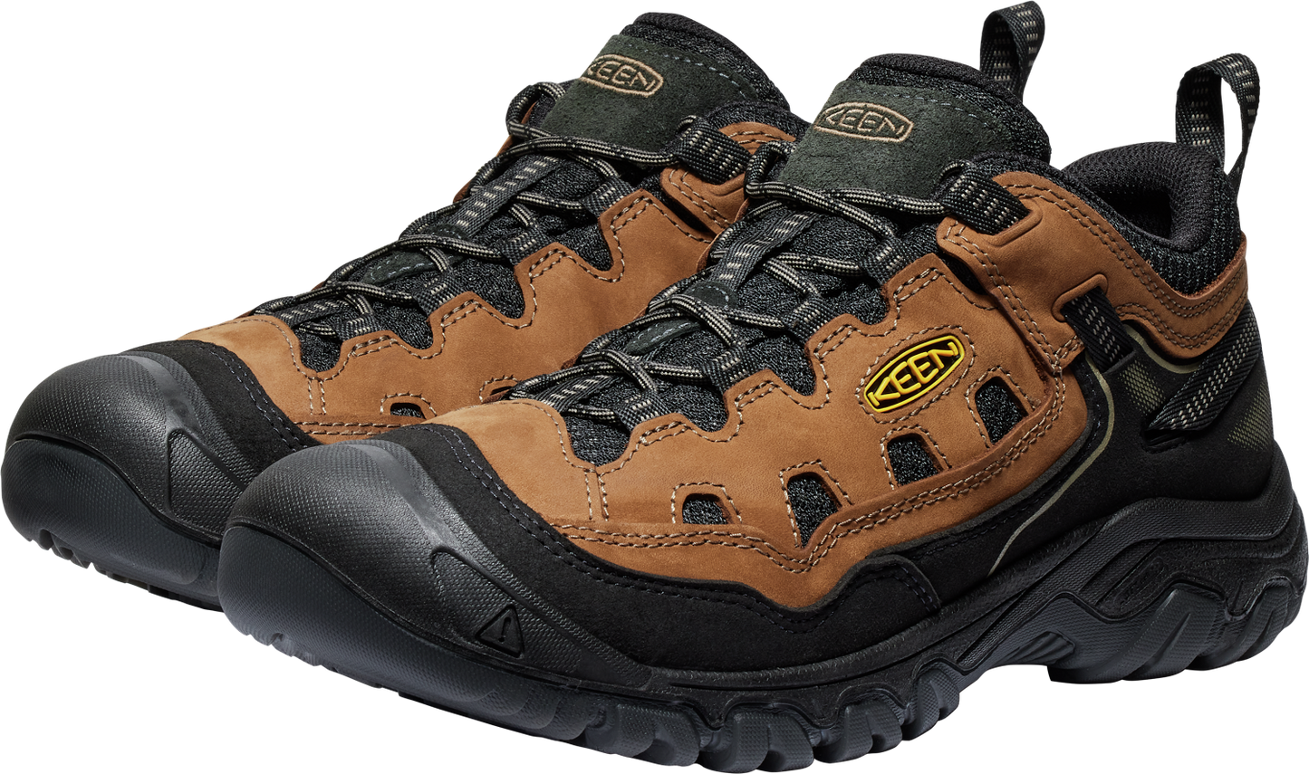 Low-cut hiking shoes with a brown leather upper, black rubber soles and toe caps, and a black padded collar.