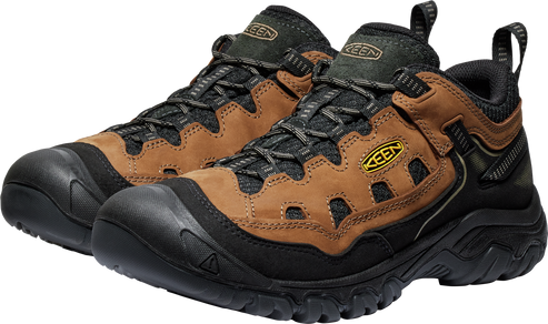 Low-cut hiking shoes with a brown leather upper, black rubber soles and toe caps, and a black padded collar.