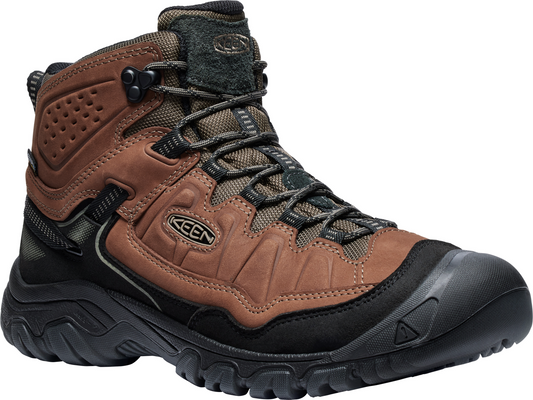 A high-cut brown hiking boot with black sole and laces.