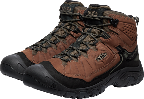 Hiking boots in brown leather with black soles and laces, featuring a rounded toe with a toe cap.