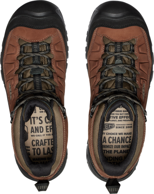 A pair of hiking boots with brown leather uppers, black rubber toe caps, and patterned laces, viewed from directly above, showing the inner linings with printed text.
