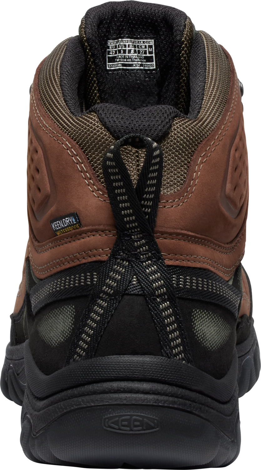Rear view of a mid-height brown and black hiking boot with a pull tab.