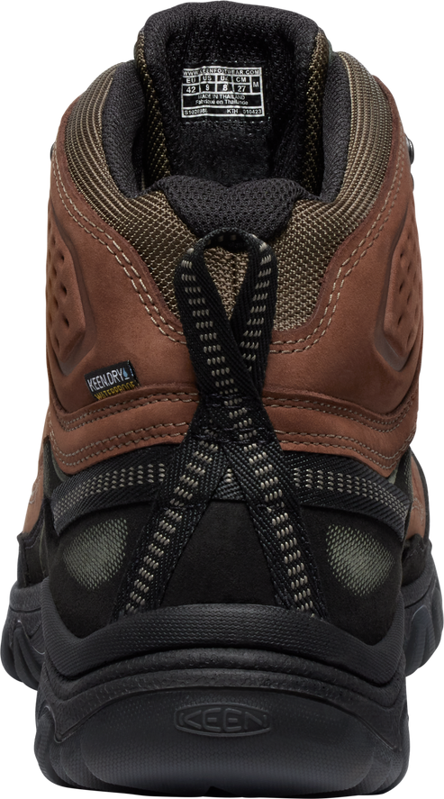 Rear view of a mid-height brown and black hiking boot with a pull tab.
