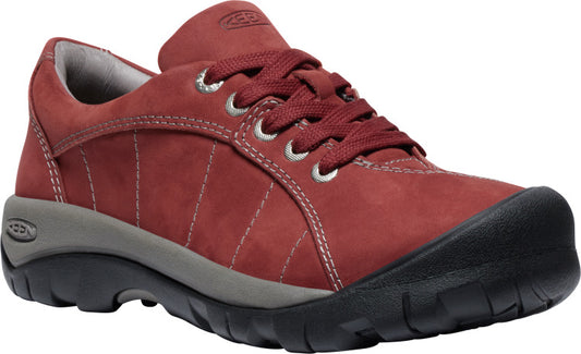 A red casual shoe with a black rubber toe.