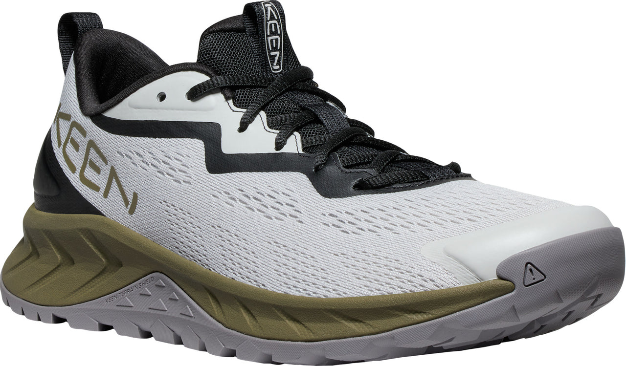 A white sneaker with black laces, a gray toe cap, and a thick olive and gray sole. "KEEN" is printed in large letters on the side.