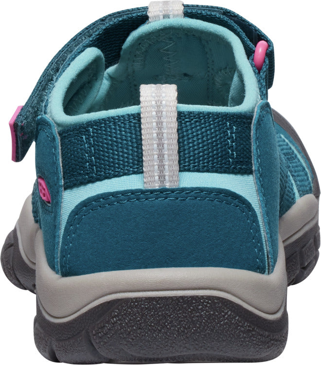 Rear view of a teal and blue sandal with a velcro strap.