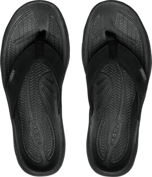 A pair of black flip-flops with textured insoles and black straps.