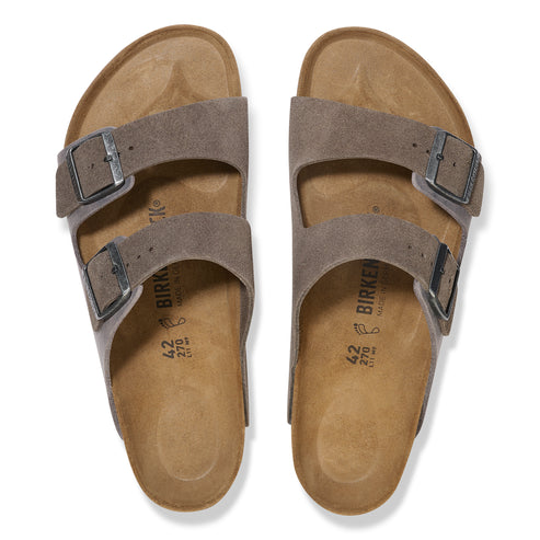 Two-strap slide sandals in taupe with adjustable buckles.