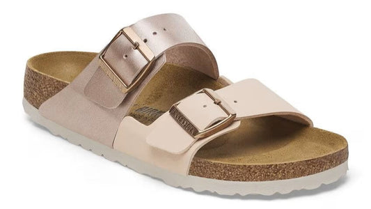 Slide sandal with two adjustable straps, a cork footbed, and metal buckles.