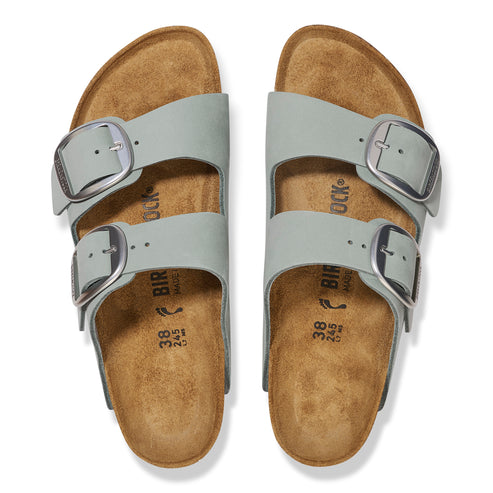 Overhead view of two light gray slide sandals with adjustable silver buckles.