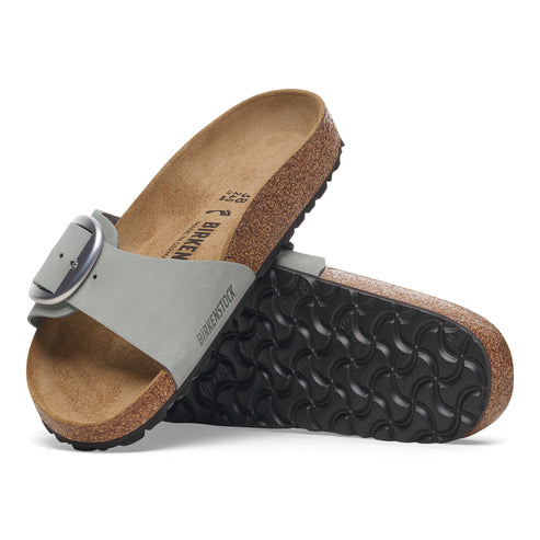Pair of Birkenstock sandals, one on top of the other, showing grey leather strap with silver buckle and black sole.