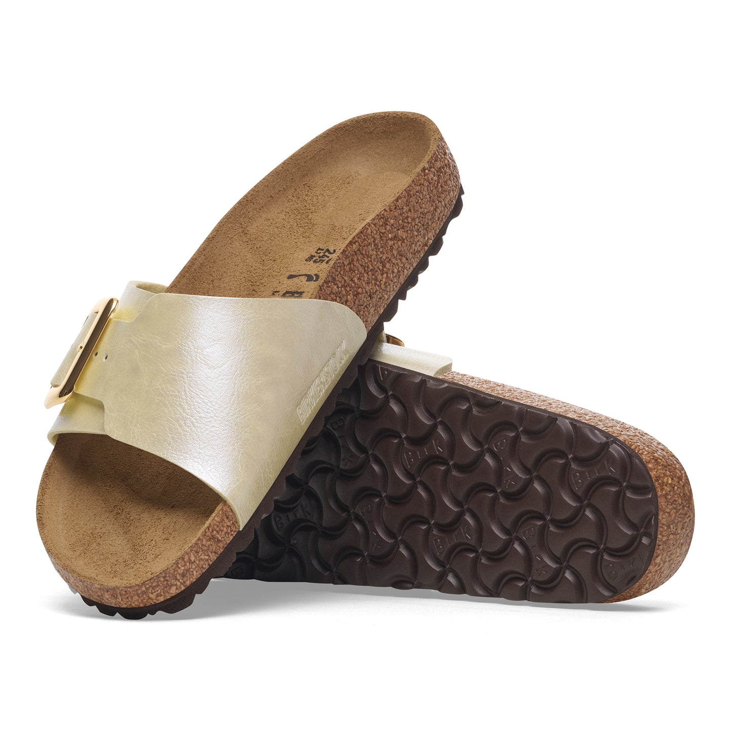 Pair of slide sandals with gold straps, cork soles and dark brown textured bottoms.