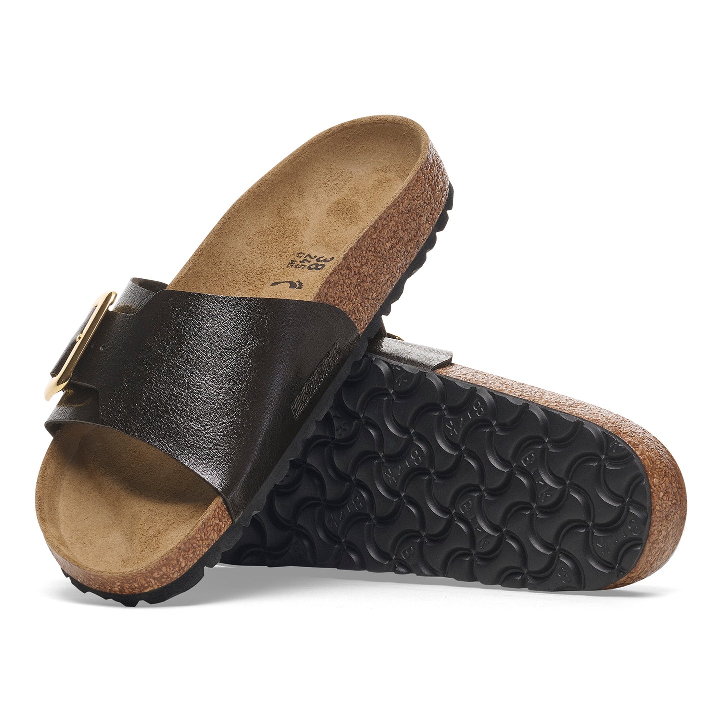 Pair of brown cork slide sandals, one atop the other.