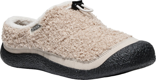 Beige slipper with black sole, cream trim, and faux fur exterior.
