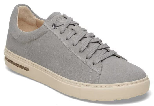 Gray suede low top sneaker with off-white sole and laces.