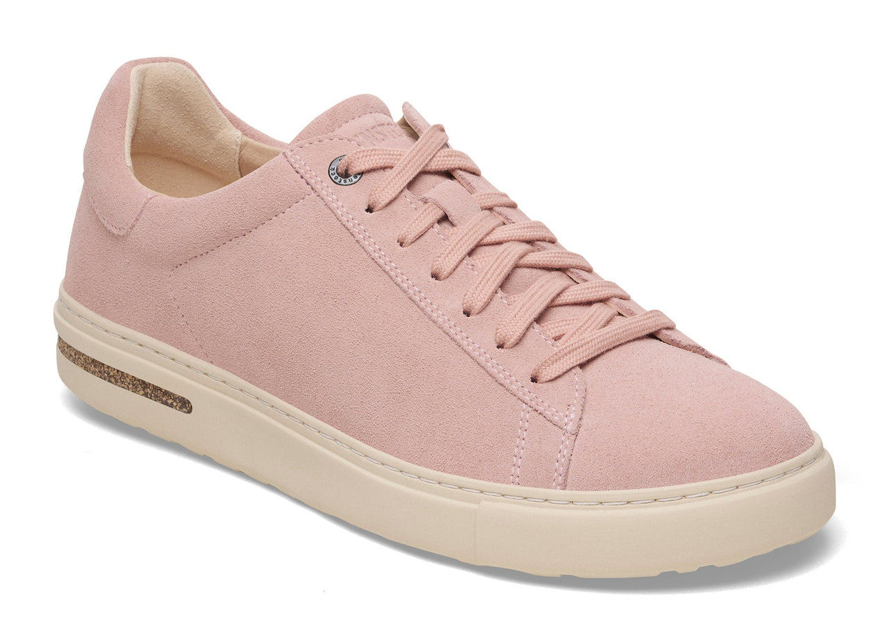 Pink leather sneaker with laces and a white sole.