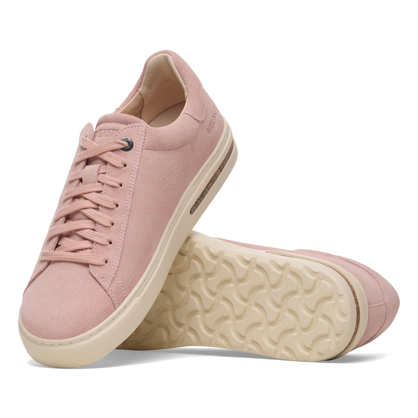 Pair of low-rise pink sneakers with a white sole and lace-up closure.