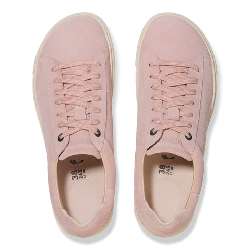 Pair of pink tennis shoes, viewed from above.