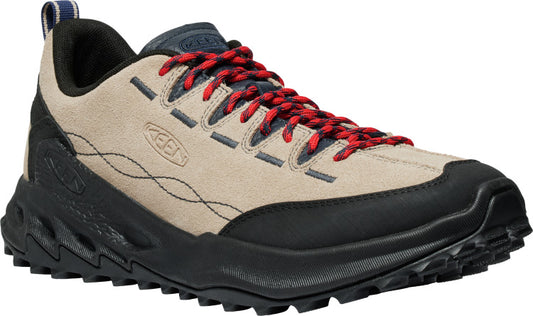 A low-top hiking shoe in tan suede with a black sole and toe bumper, and red and navy laces.