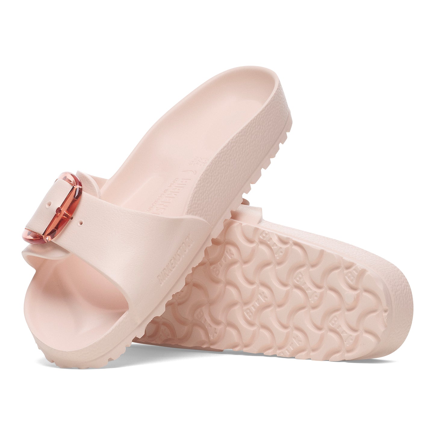 Pair of pink slides with an adjustable rose gold buckle, showing textured soles.