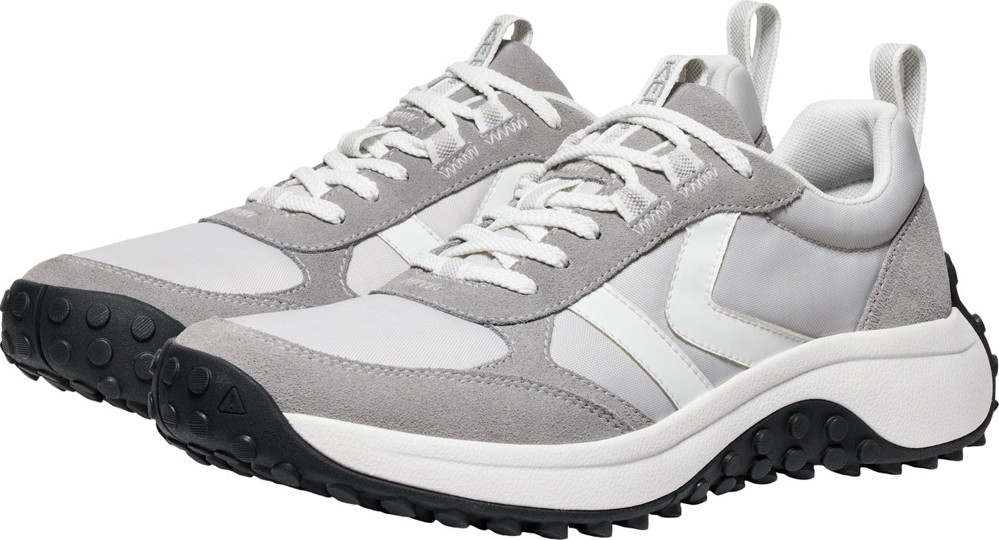 A pair of gray and white sneakers with white laces and a black treaded sole.