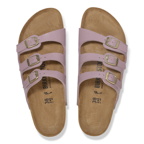 A pair of lilac three-strap slide sandals with adjustable gold buckles.