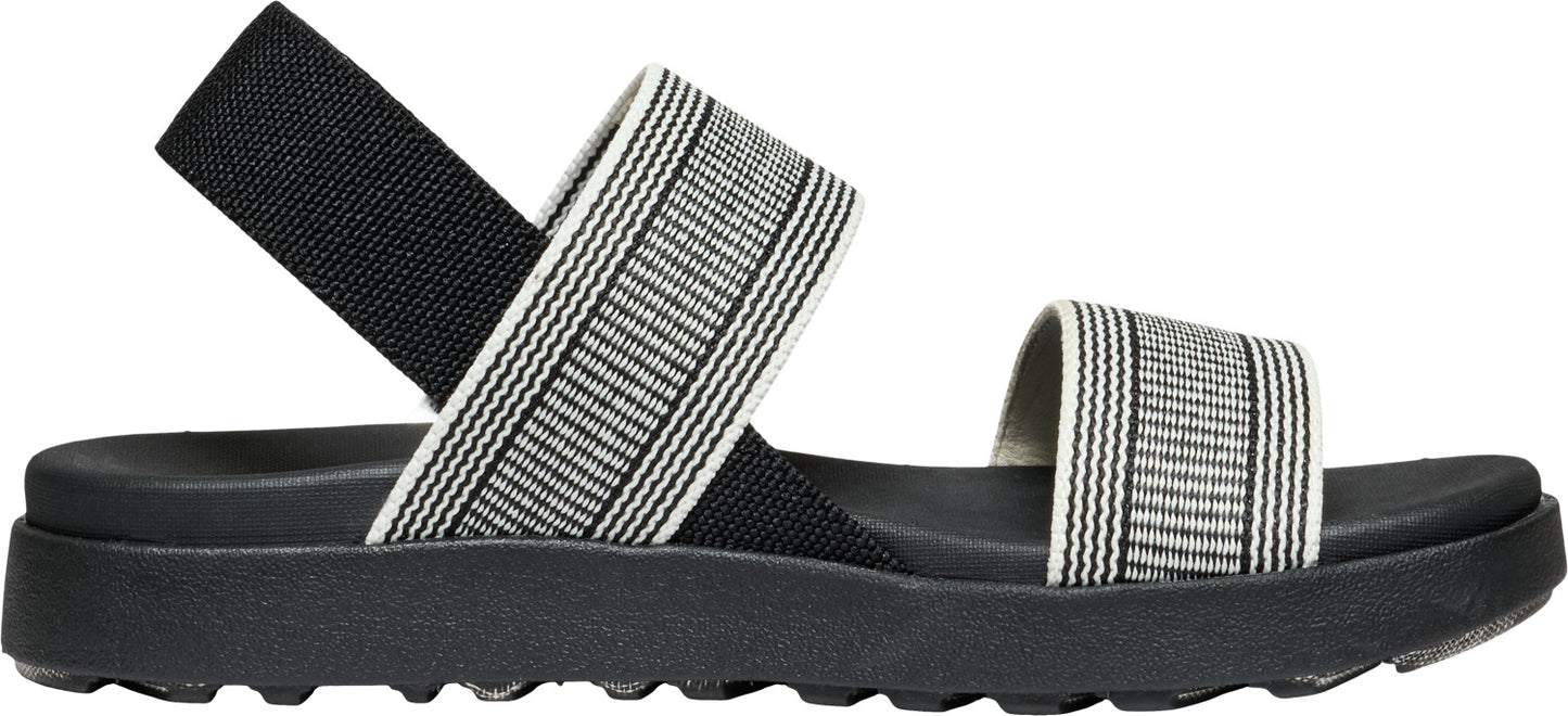 A sandal with black soles and striped straps.