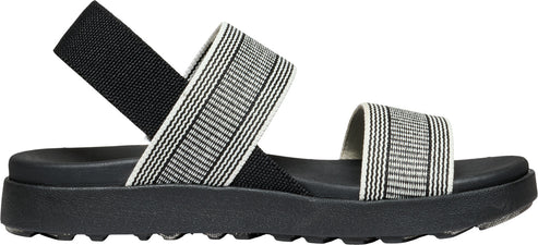 A sandal with black soles and striped straps.