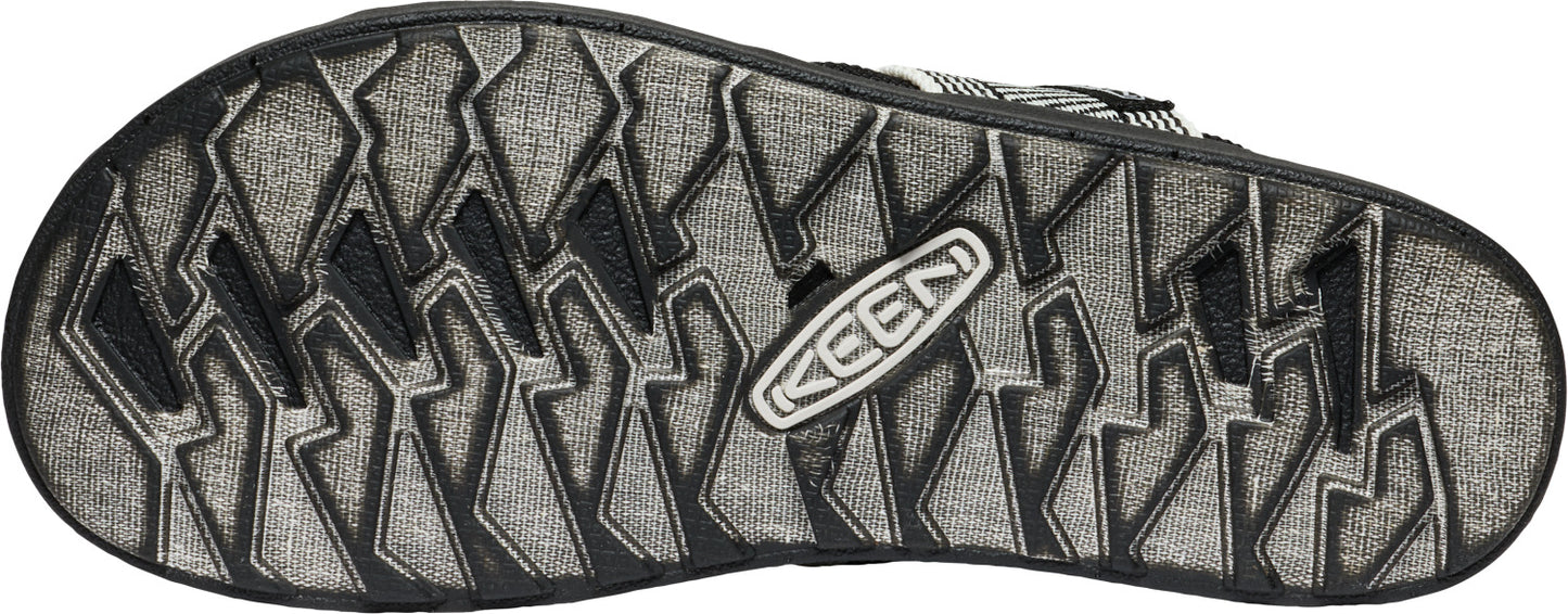 Shoe sole with black tread pattern and a KEEN logo.