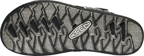 Shoe sole with black tread pattern and a KEEN logo.