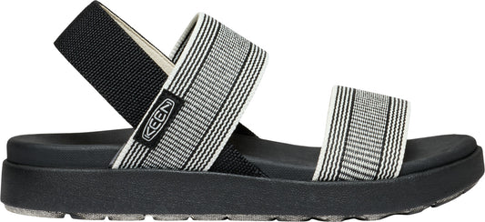 A sandal with a thick black sole, black back strap, and striped gray and white elastic bands.