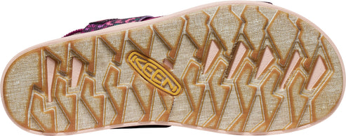 A close-up of the textured sole of a sandal, showcasing a KEEN logo.