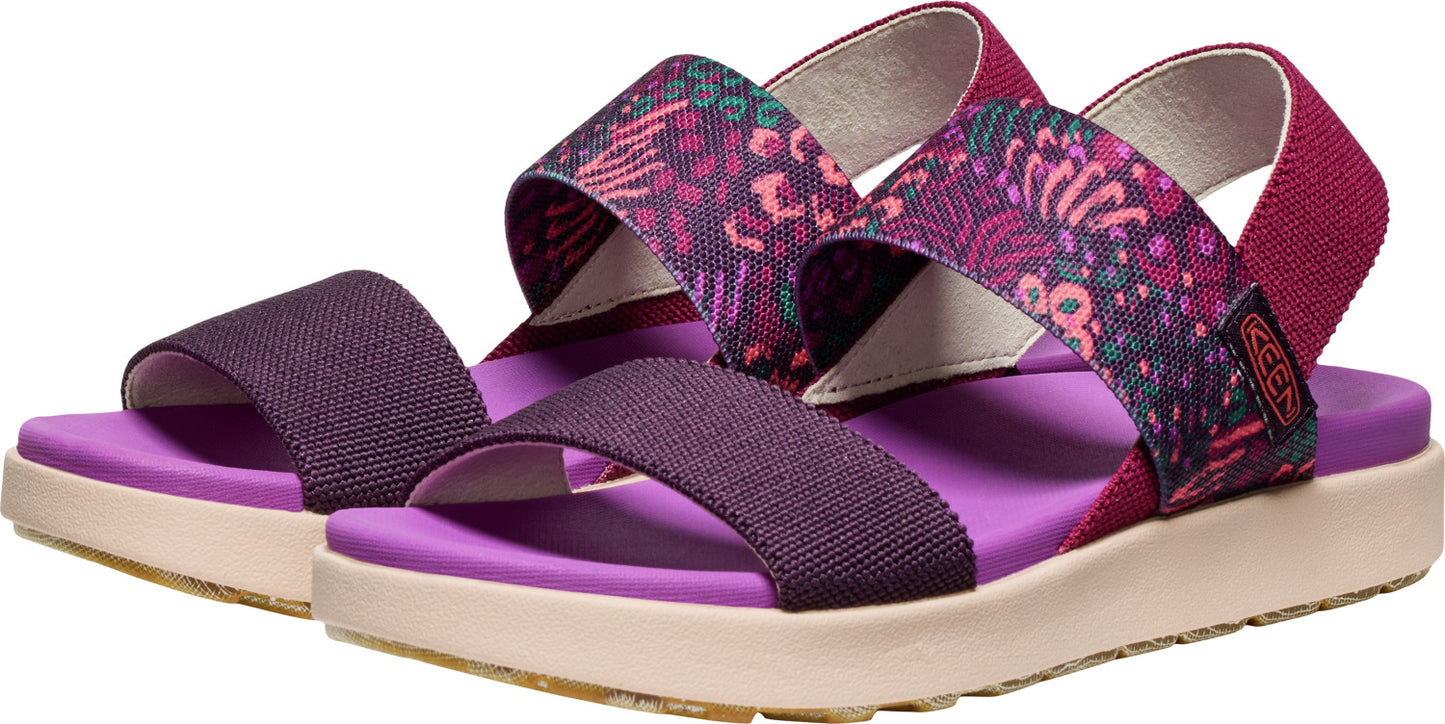 A pair of purple patterned sandals with a lavender colored sole.