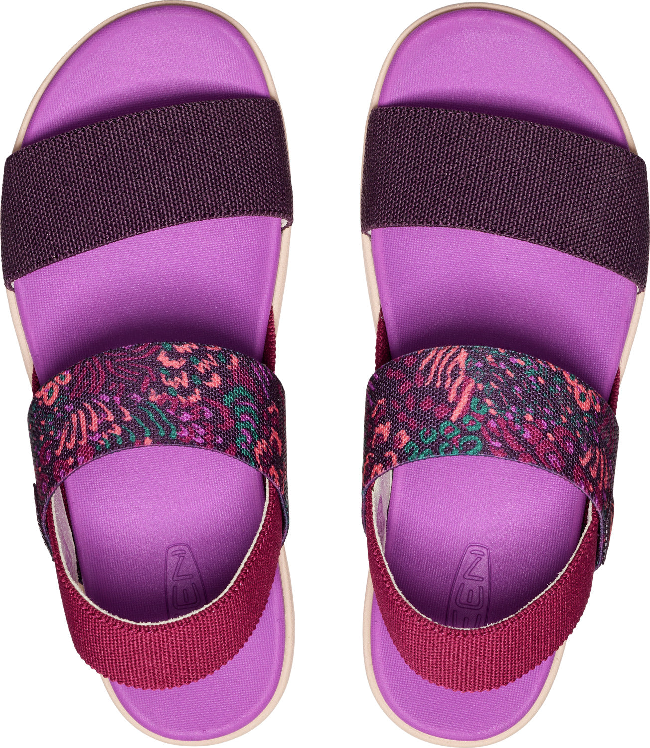 Overhead view of two lavender sandals. They have thick, elastic bands across the toes and instep. The band across the toe is a solid plum, and the band across the instep is printed with dark pink, magenta, and dark green floral designs.