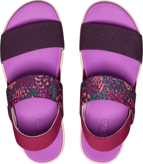 Overhead view of two lavender sandals. They have thick, elastic bands across the toes and instep. The band across the toe is a solid plum, and the band across the instep is printed with dark pink, magenta, and dark green floral designs.