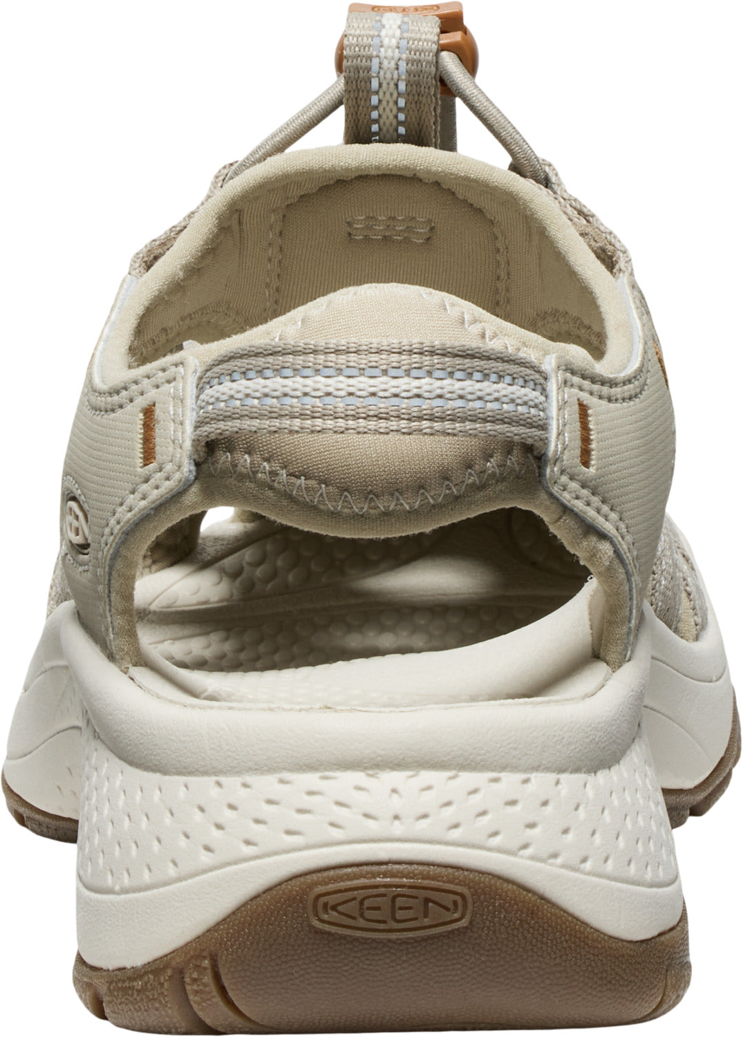 Tan-colored sandal with open toe and heel, adjustable bungee cord, and textured sole with logo.