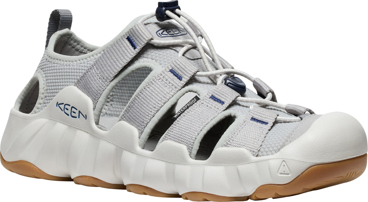 Light gray athletic shoe with a white midsole and brown outsole. The shoe features a drawstring closure and open sides with KEEN branding.