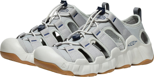 A pair of light gray closed-toe sandals with brown soles and white bumpers.