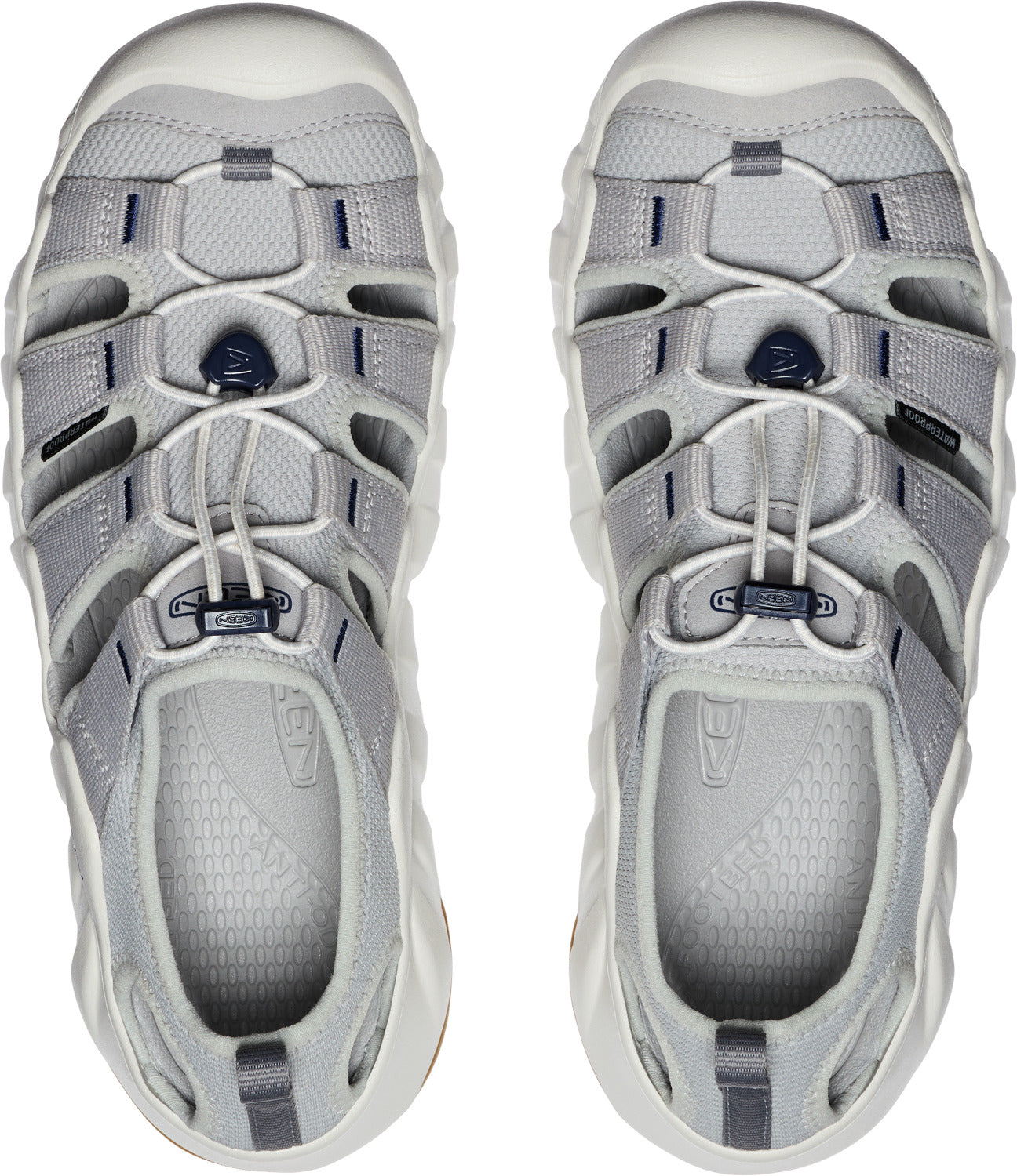 A pair of grey open-toed sandals with cord laces and chunky white soles.
