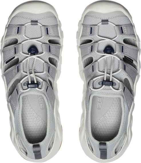 A pair of grey open-toed sandals with cord laces and chunky white soles.