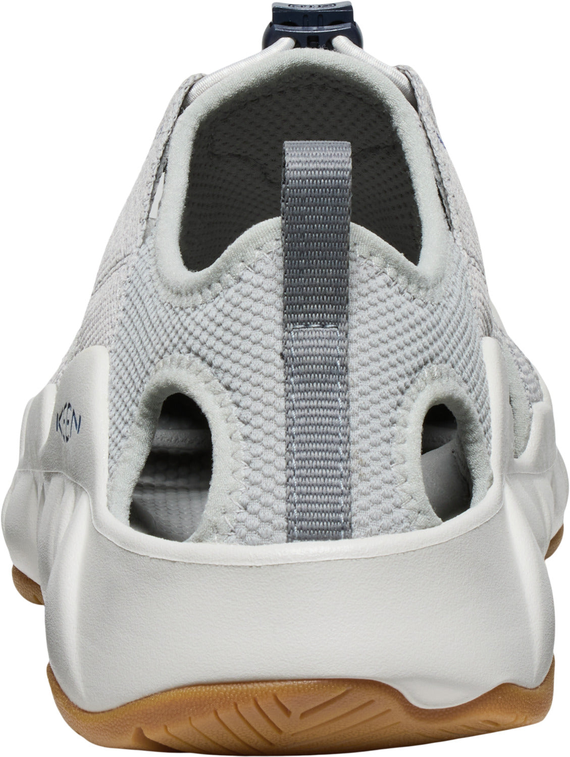 The back of a gray and white shoe with large oval cutouts and brown sole.