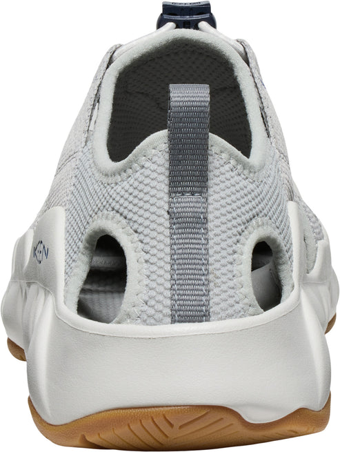 The back of a gray and white shoe with large oval cutouts and brown sole.